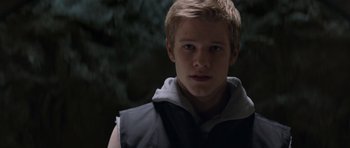 Movie still from “X-Men: First Class” (2011), directed by Matthew Vaughn – A young man in a black vest is looking at the camera; Close Up shot, Low angle