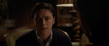 Movie still from “X-Men: First Class” (2011), directed by Matthew Vaughn – A person wearing a suit and tie; Close Up shot, Over the shoulder angle