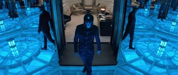 Movie still from “X-Men: First Class” (2011), directed by Matthew Vaughn – A man in a suit and helmet walks down the stairs; Wide shot, High angle