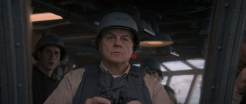 Movie still from “X-Men: First Class” (2011), directed by Matthew Vaughn – An older man in a helmet is holding a gun; Close Up shot, Low angle