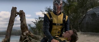 Movie still from “X-Men: First Class” (2011), directed by Matthew Vaughn – A man in a yellow and black outfit is sitting on a man; Medium shot, Over the shoulder angle