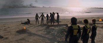 Movie still from “X-Men: First Class” (2011), directed by Matthew Vaughn – A group of people standing on top of a sandy beach; Wide shot, High angle