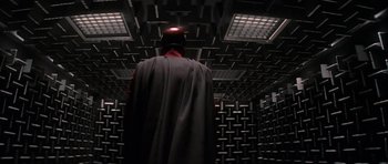 Movie still from “X-Men: First Class” (2011), directed by Matthew Vaughn – A man in a cape and helmet stands in an empty room; Wide shot, Low angle