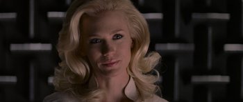 Movie still from “X-Men: First Class” (2011), directed by Matthew Vaughn – A woman with blonde hair and blue eye shadow; Close Up shot, Over the shoulder angle