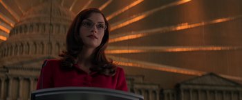 Movie still from “X-Men” (2000), directed by Bryan Singer – A woman in a red jacket and glasses; Medium shot, Low angle
