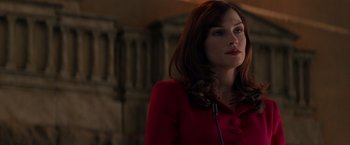 Movie still from “X-Men” (2000), directed by Bryan Singer – A woman in a red jacket is looking to her left; Close Up shot, Over the shoulder angle