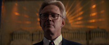 Movie still from “X-Men” (2000), directed by Bryan Singer – An older man wearing glasses and a suit; Close Up shot, Low angle