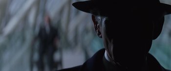 Movie still from “X-Men” (2000), directed by Bryan Singer – A person wearing a hat; Close Up shot, Over the shoulder angle