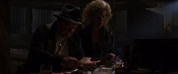 Movie still from “X-Men” (2000), directed by Bryan Singer – A man and a woman sitting at a dinner table; Medium shot, Low angle