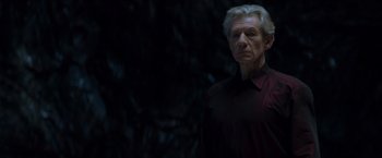 Movie still from “X-Men” (2000), directed by Bryan Singer – An older man wearing a black shirt standing in front of a dark background; Close Up shot, Low angle