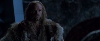 Movie still from “X-Men” (2000), directed by Bryan Singer – A man with long blonde hair wearing a fur coat; Close Up shot, Over the shoulder angle