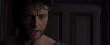 Movie still from “X-Men” (2000), directed by Bryan Singer – A person with a beard; Close Up shot, Over the shoulder angle