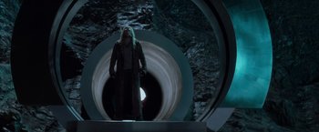 Movie still from “X-Men” (2000), directed by Bryan Singer – A man standing inside of a tunnel with lights on it; Wide shot, Low angle