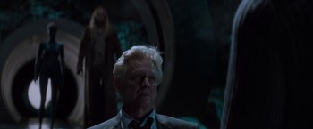 Movie still from “X-Men” (2000), directed by Bryan Singer – An older man in a suit and tie looking at the camera; Medium shot, Over the shoulder angle