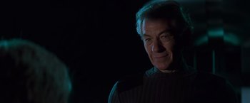 Movie still from “X-Men” (2000), directed by Bryan Singer – An older man in a sweater is looking at the camera; Close Up shot, Over the shoulder angle
