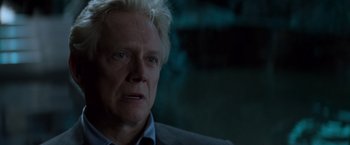 Movie still from “X-Men” (2000), directed by Bryan Singer – An older man with white hair and a blue shirt; Close Up shot, Over the shoulder angle