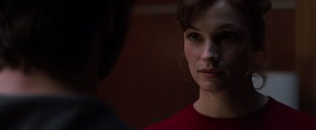 Movie still from “X-Men” (2000), directed by Bryan Singer – A person wearing a red shirt; Close Up shot, Over the shoulder angle