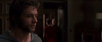 Movie still from “X-Men” (2000), directed by Bryan Singer – A person in a room near a door; Close Up shot, Over the shoulder angle