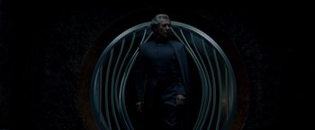 Movie still from “X-Men” (2000), directed by Bryan Singer – An older man standing in front of a circular structure; Medium shot, Low angle