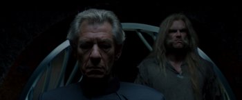 Movie still from “X-Men” (2000), directed by Bryan Singer – A man with a beard and a man with long white hair; Close Up shot, Over the shoulder angle
