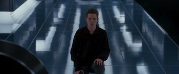 Movie still from “X-Men” (2000), directed by Bryan Singer – A man sitting on the ground in a dark room; Medium shot, Low angle