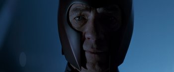 Movie still from “X-Men” (2000), directed by Bryan Singer – An old man wearing a helmet and looking at the camera; Close Up shot, Low angle