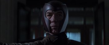 Movie still from “X-Men” (2000), directed by Bryan Singer – A person wearing a helmet; Close Up shot, Low angle