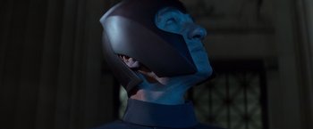 Movie still from “X-Men” (2000), directed by Bryan Singer – A person wearing a helmet with a blue face; Close Up shot, Low angle