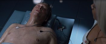 Movie still from “X-Men” (2000), directed by Bryan Singer – A man laying on a bed with wires attached to his chest; Close Up shot, Overhead angle