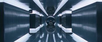 Movie still from “X-Men” (2000), directed by Bryan Singer – A person sitting in a room that has a lot of lights in it; Extreme Wide shot, Overhead angle