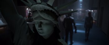 Movie still from “X-Men” (2000), directed by Bryan Singer – A statue of the statue of liberty wearing a crown; Close Up shot, Over the shoulder angle