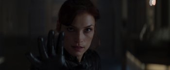 Movie still from “X-Men” (2000), directed by Bryan Singer – A person holding something up; Close Up shot, Over the shoulder angle