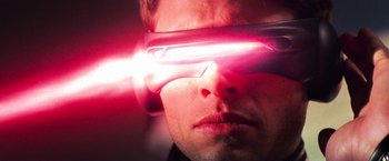 Movie still from “X-Men” (2000), directed by Bryan Singer – A person wearing a pair of glasses; Close Up shot, Low angle