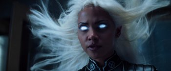 Movie still from “X-Men” (2000), directed by Bryan Singer – A person with white hair wearing a costume; Close Up shot, Low angle