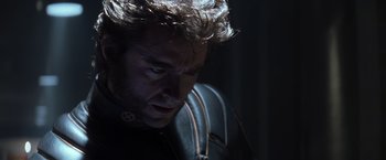 Movie still from “X-Men” (2000), directed by Bryan Singer – A person wearing a black shirt; Close Up shot, Over the shoulder angle