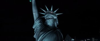 Movie still from “X-Men” (2000), directed by Bryan Singer – The statue of liberty is lit up at night; Medium shot, Low angle