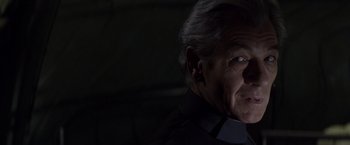Movie still from “X-Men” (2000), directed by Bryan Singer – An older man in a black shirt is looking at the camera; Close Up shot, Over the shoulder angle