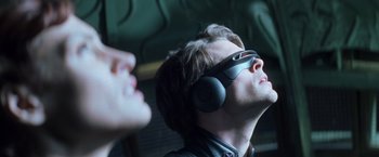 Movie still from “X-Men” (2000), directed by Bryan Singer – A young man wearing a pair of headphones and looking up; Close Up shot, Low angle