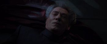 Movie still from “X-Men” (2000), directed by Bryan Singer – An older man with grey hair sleeping on a couch; Close Up shot, Overhead angle