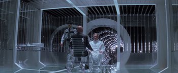 Movie still from “X-Men” (2000), directed by Bryan Singer – A group of people standing next to each other in a room; Wide shot, High angle