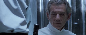 Movie still from “X-Men” (2000), directed by Bryan Singer – A man in a white shirt is looking at a mirror; Close Up shot, Over the shoulder angle