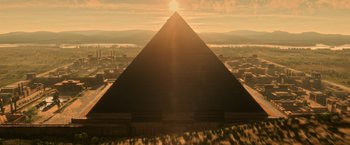 Movie still from “X-Men: Apocalypse” (2016), directed by Bryan Singer – An aerial view of a large pyramid in the middle of a city; Extreme Wide shot, Low angle