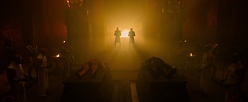 Movie still from “X-Men: Apocalypse” (2016), directed by Bryan Singer – Two men are standing in the light in a dark room; Wide shot, Low angle