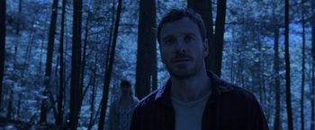 Movie still from “X-Men: Apocalypse” (2016), directed by Bryan Singer – A man and a woman standing in the woods at night; Medium shot, Low angle