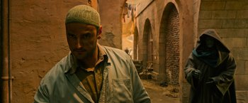 Movie still from “X-Men: Apocalypse” (2016), directed by Bryan Singer – A man with a green hat standing in an alley way; Close Up shot, Low angle