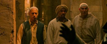 Movie still from “X-Men: Apocalypse” (2016), directed by Bryan Singer – A group of men standing next to each other in a room; Medium shot, Over the shoulder angle