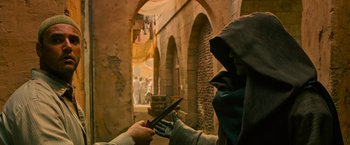 Movie still from “X-Men: Apocalypse” (2016), directed by Bryan Singer – A person is holding a tablet in a medieval setting; Medium shot, Over the shoulder angle