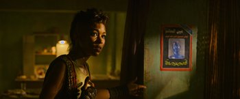 Movie still from “X-Men: Apocalypse” (2016), directed by Bryan Singer – A woman standing next to a wall in a dark room; Close Up shot, Over the shoulder angle