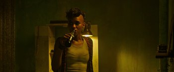 Movie still from “X-Men: Apocalypse” (2016), directed by Bryan Singer – A woman is drinking a beer in the dark; Close Up shot, Over the shoulder angle
