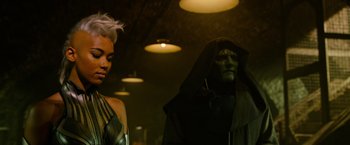 Movie still from “X-Men: Apocalypse” (2016), directed by Bryan Singer – A woman and a man in a black costume; Close Up shot, Over the shoulder angle